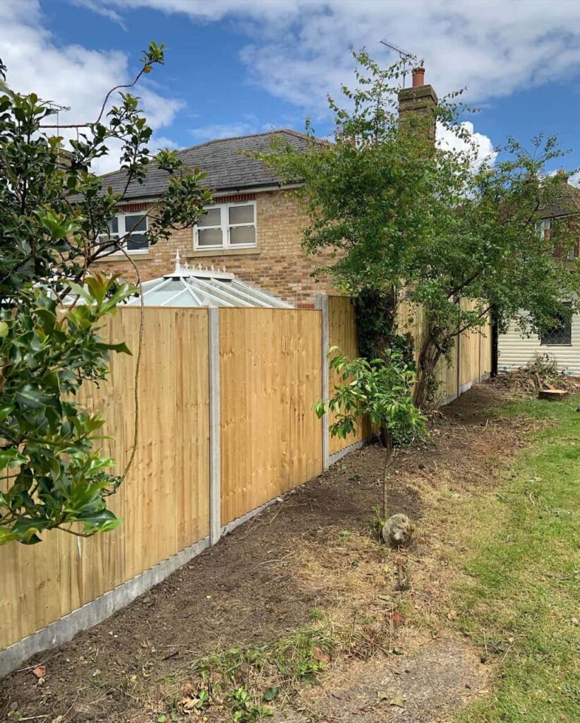 This is a photo of fence panels installed in a residential garden using concrete posts and gravel boards. Installed by Fast Fix Fencing Eaton